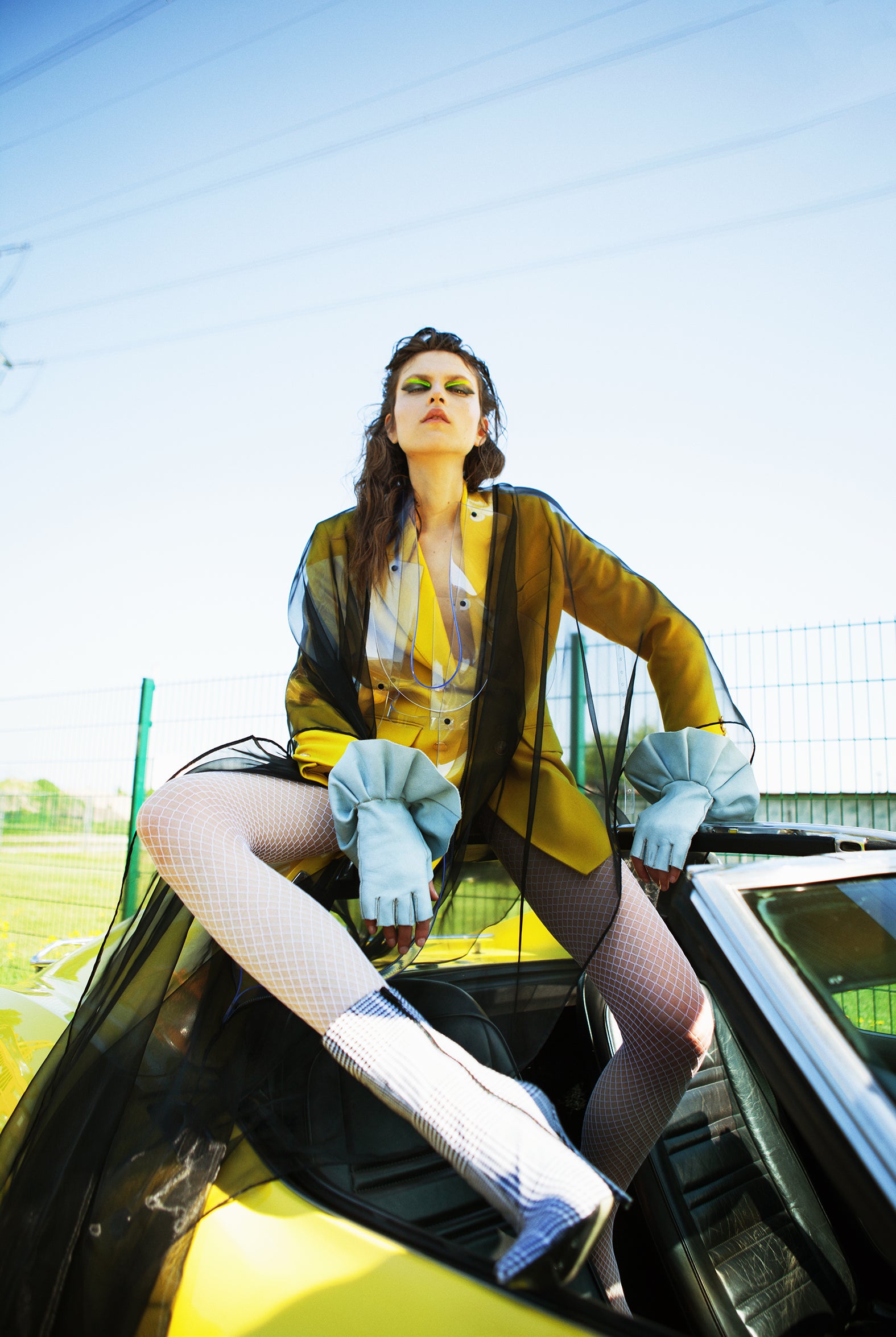 Blanc Magazine x Jivomir Domoustchiev Shear black tulle dress with exagerated vinyl shoulder pads and trim