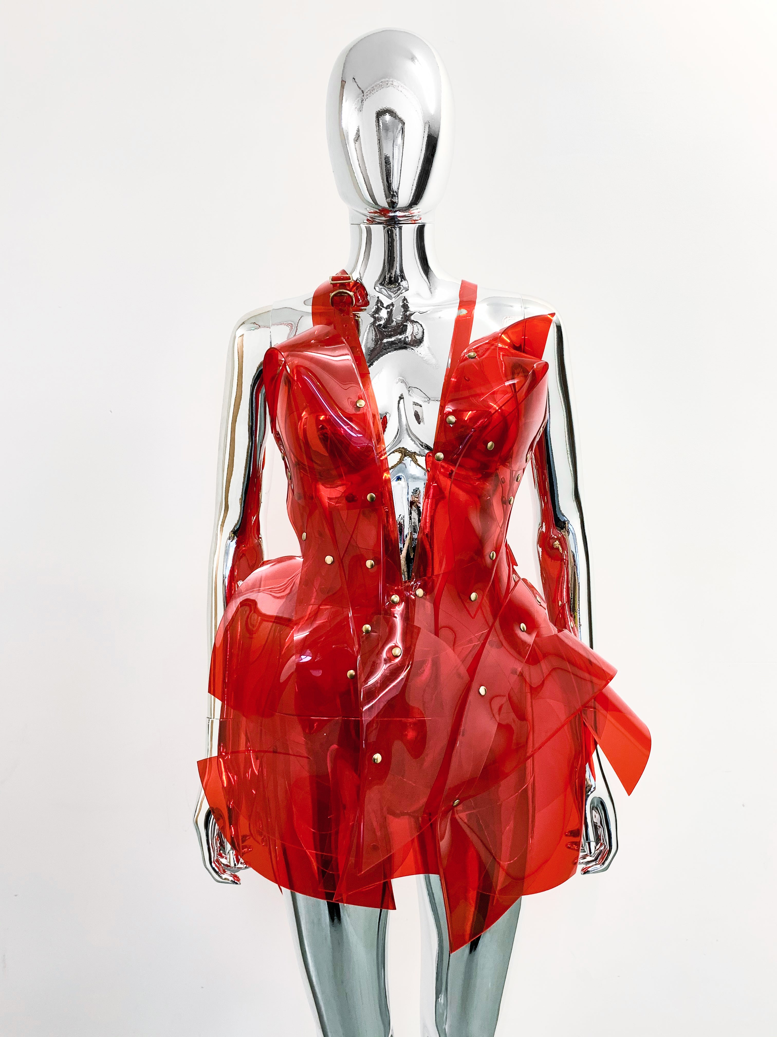 'Onna Bugeisha' collection Jivomir Domoustchiev Asymmetric V Dress lovingly made to order in our east London atelier in vegan vinyl and available in a variety of stunning colours and studding details. An artist expression pure asymmetrical balance contact@jivomirdomoustchiev.com As with all Jivomir Domoustchiev pieces are hand crafted to order please allow up to 4 weeks for shipping.  Shown in clear Valentines Red.