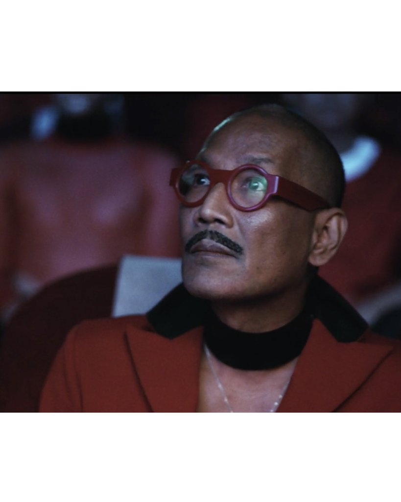 Jivomir Domoustchiev iconic vinyl chocker as seen in the Year and Years Sanctify video. available in a variety of colours. Simple yet striking adjustable for comfort. Finished with silver look studding & buckle. Complements any outfit.