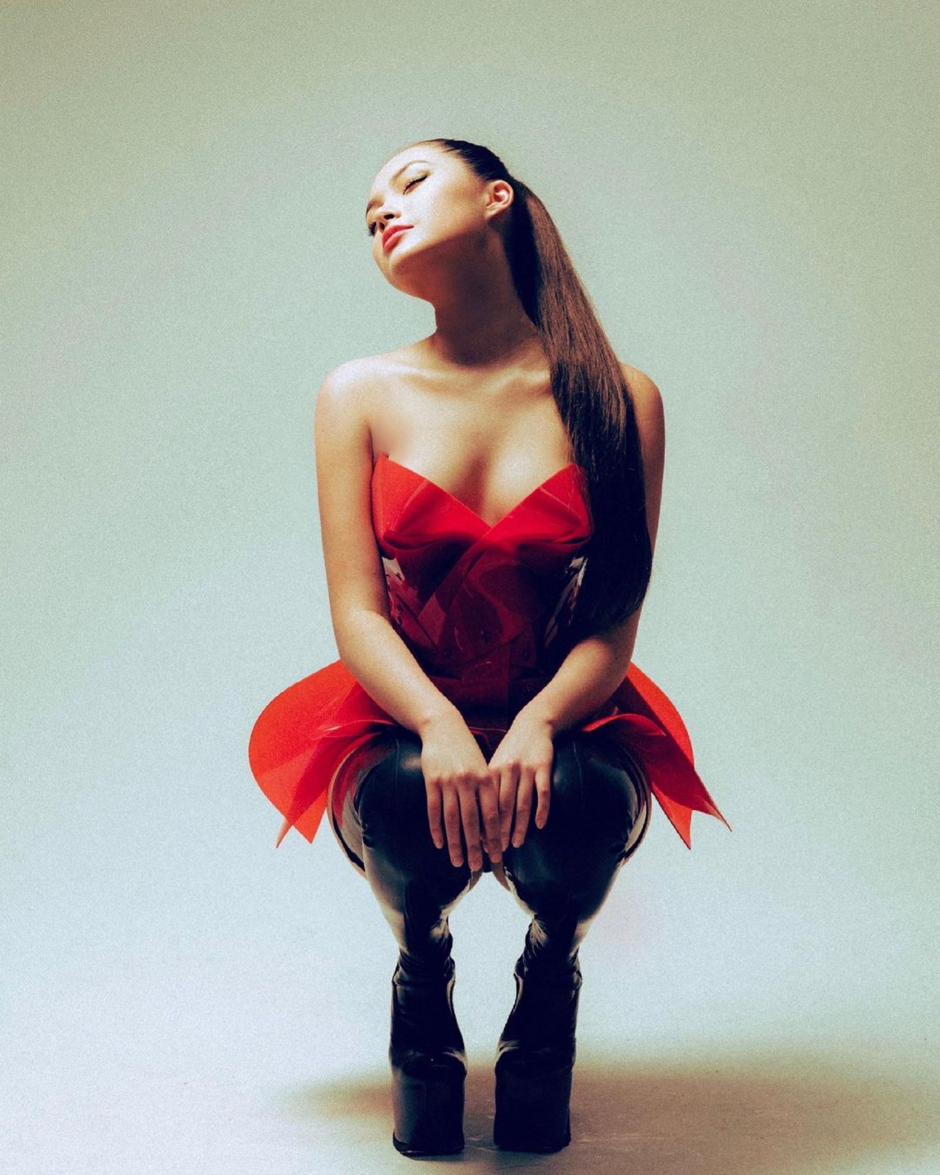 Chantelle Lee wearing ATÉLIER JIVOMIR Mini VEGAN VINYL sculpture red dress