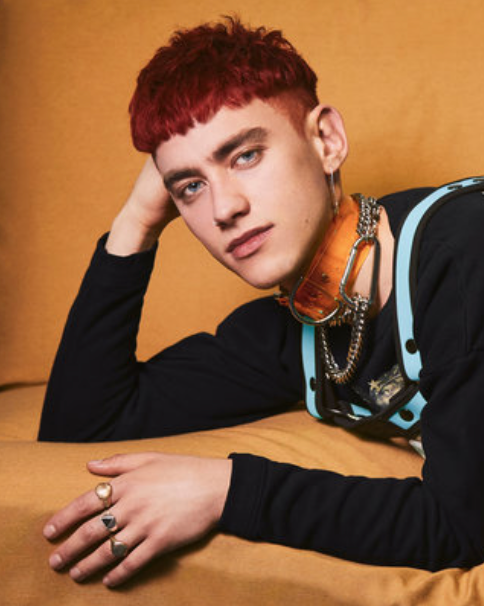 Olly Alexander from the band Years and Years wearing Jivomir Domoustchiev clear yellow vinyl collar for Paper Magazine