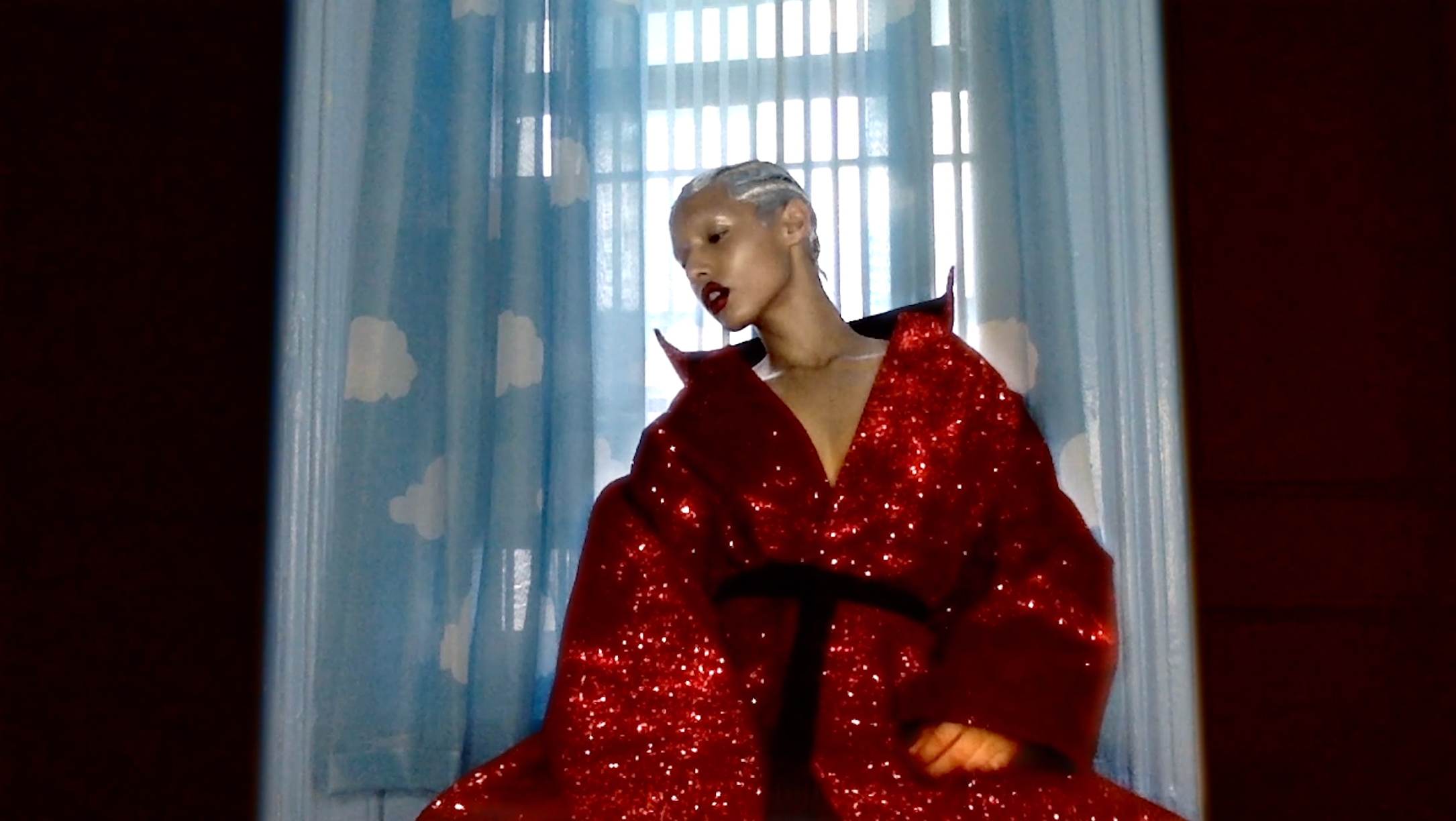 Jazzelle Zanaughtti for Showstudio by Nick Knight wearing ATÉLIER JIVOMIR RED GLITTER COAT