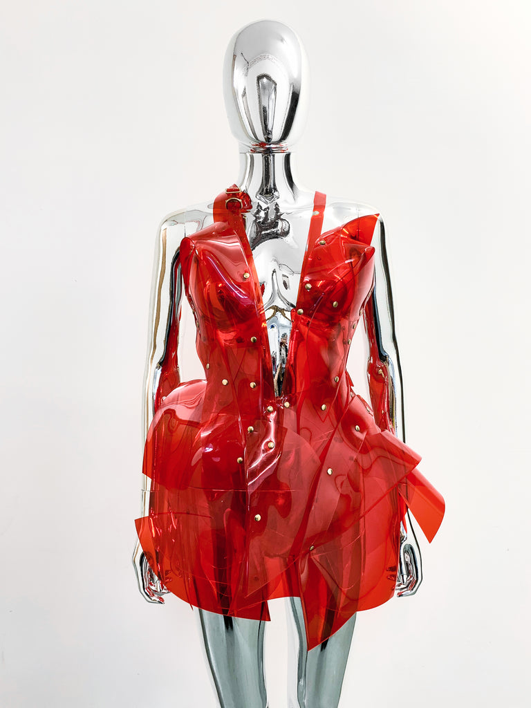  'Onna Bugeisha' collection Jivomir Domoustchiev Asymmetric V Dress lovingly made to order in our east London atelier in vegan vinyl and available in a variety of stunning colours and studding details. An artist expression pure asymmetrical balance contact@jivomirdomoustchiev.com As with all Jivomir Domoustchiev pieces are hand crafted to order please allow up to 4 weeks for shipping.  Shown in clear Valentines Red.